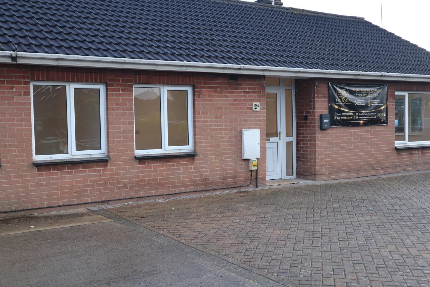 Longlevens Bungalow brick exterior and paved driveway